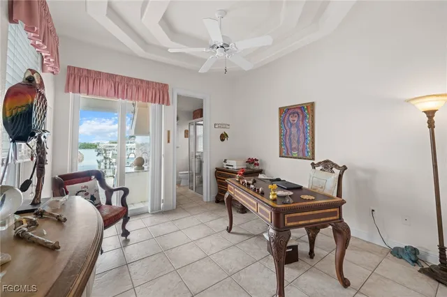 a room with furniture a desk and chair with the potted plants