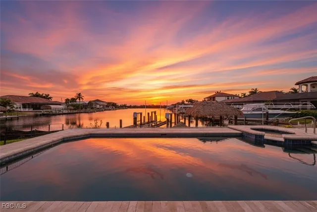 a view of swimming pool with a table and chairs