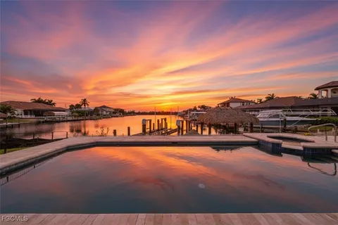a living room with fireplace furniture and a potted plant