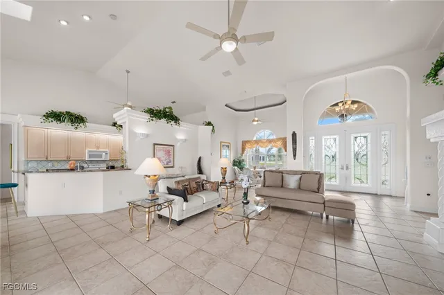 a living room with furniture and a kitchen area