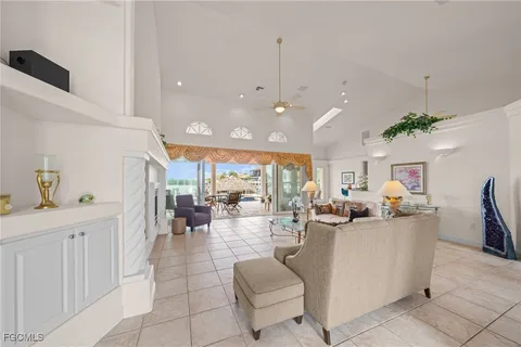 a dining room with furniture a chandelier and fireplace