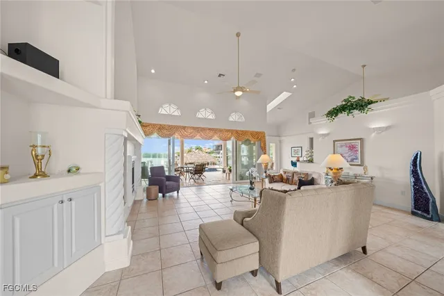 a living room with fireplace furniture and a potted plant