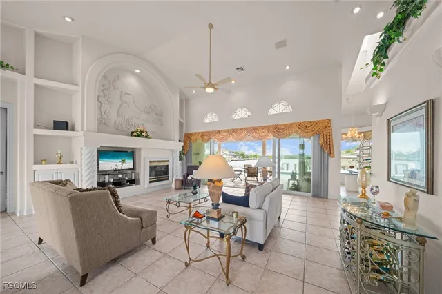 a living room with fireplace furniture and a large window