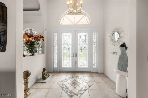 a spacious bedroom with a bed and a chandelier