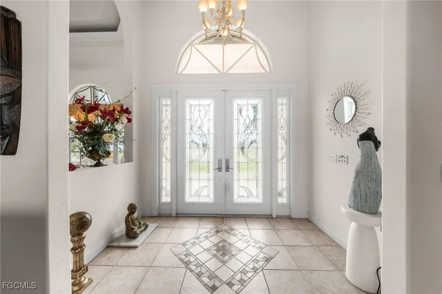 a view of a room with windows and flowers