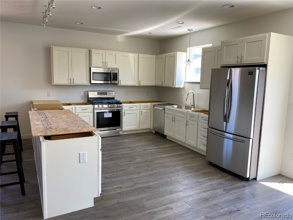 347 Lake View Road Hayden, CO 81639 - Photo 3 of 19 a kitchen with granite countertop stainless steel appliances a refrigerator a sink and a stove