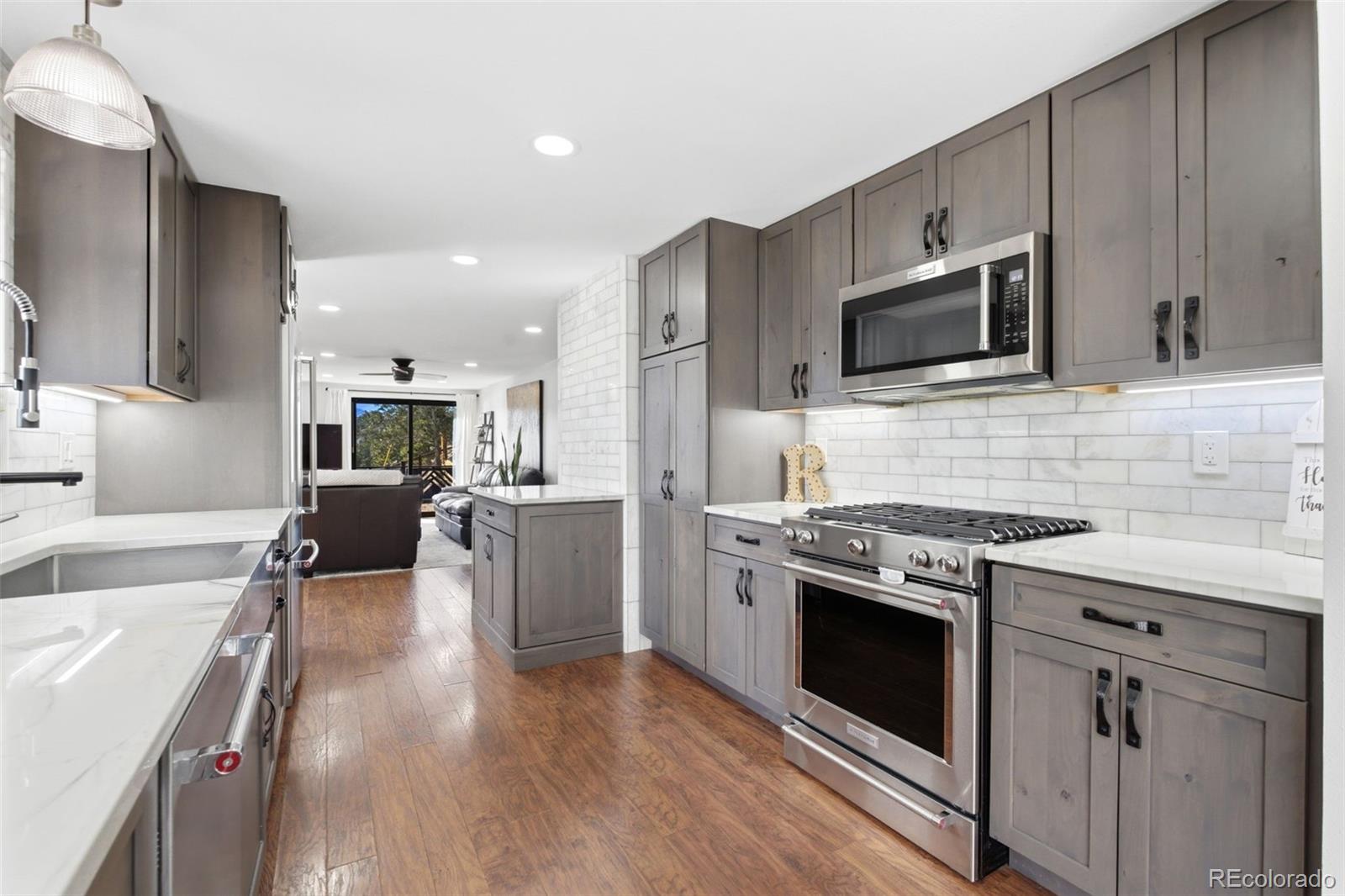 3155 Chestnut Circle Evergreen, CO 80439 - Photo 11 of 50 a kitchen with stove a sink and refrigerator