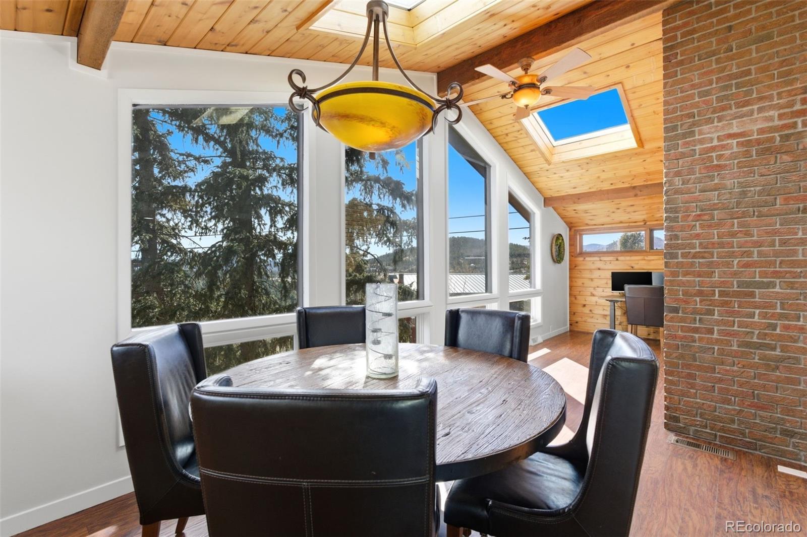 3155 Chestnut Circle Evergreen, CO 80439 - Photo 15 of 50 a view of a dining room with furniture window and outside view