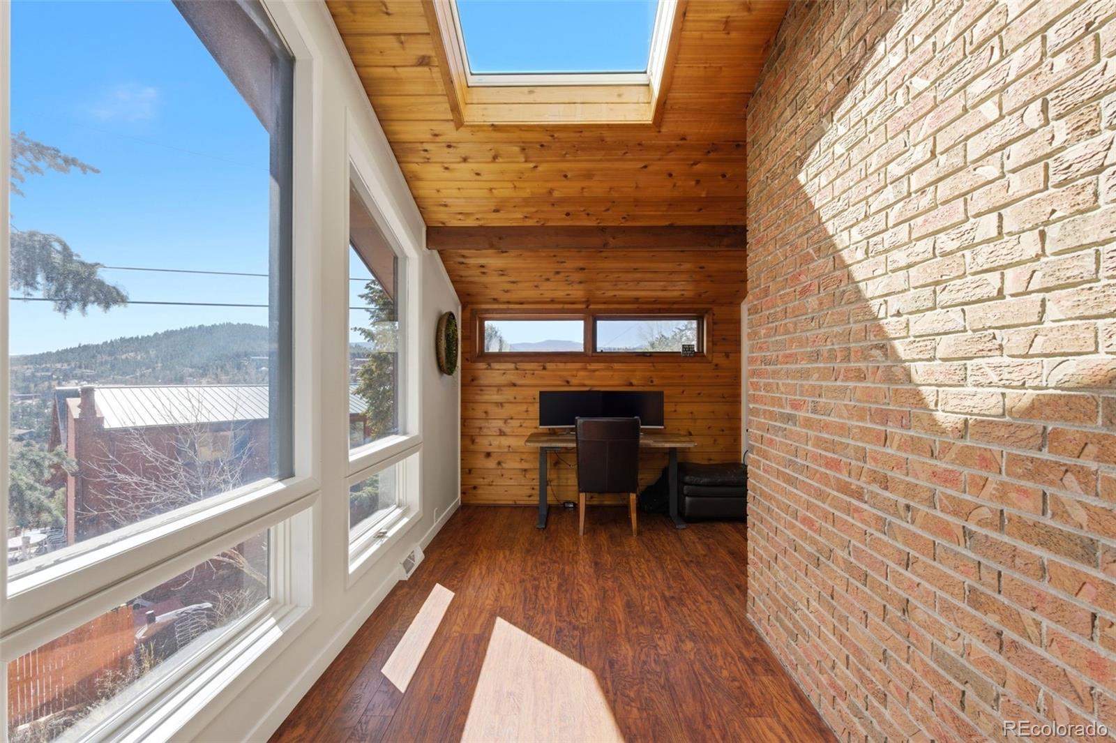 3155 Chestnut Circle Evergreen, CO 80439 - Photo 18 of 50 a view of a balcony with chairs and wooden floor