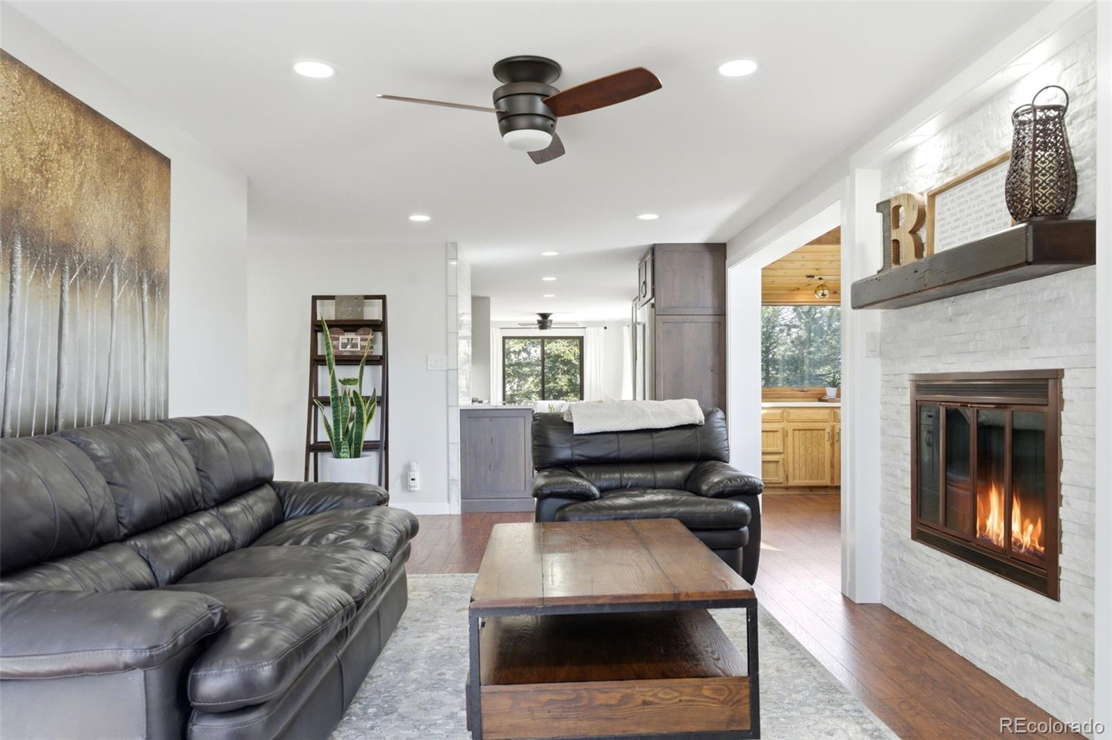 3155 Chestnut Circle Evergreen, CO 80439 - Photo 21 of 50 a living room with furniture and a fireplace