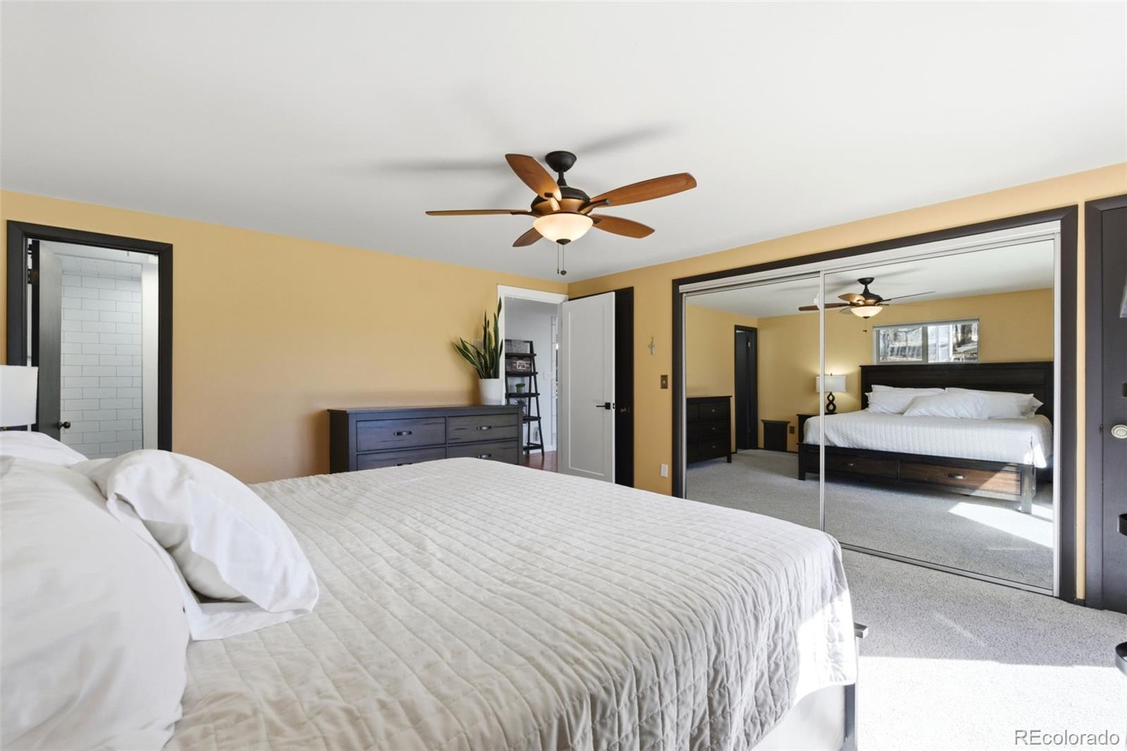 3155 Chestnut Circle Evergreen, CO 80439 - Photo 23 of 50 a bedroom with a large bed and a chandelier