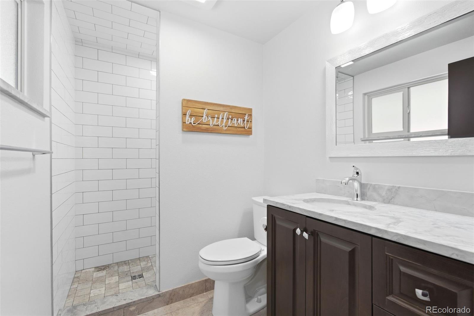 3155 Chestnut Circle Evergreen, CO 80439 - Photo 24 of 50 a bathroom with a sink a toilet and shower
