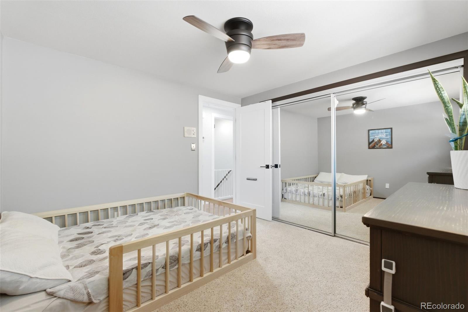 3155 Chestnut Circle Evergreen, CO 80439 - Photo 26 of 50 a bedroom with a bed and a chandelier