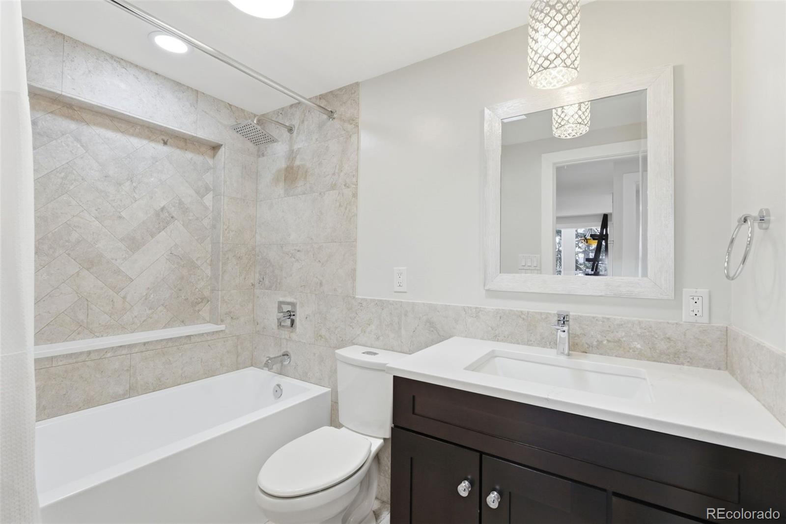 3155 Chestnut Circle Evergreen, CO 80439 - Photo 27 of 50 a bathroom with a sink a toilet a mirror and shower