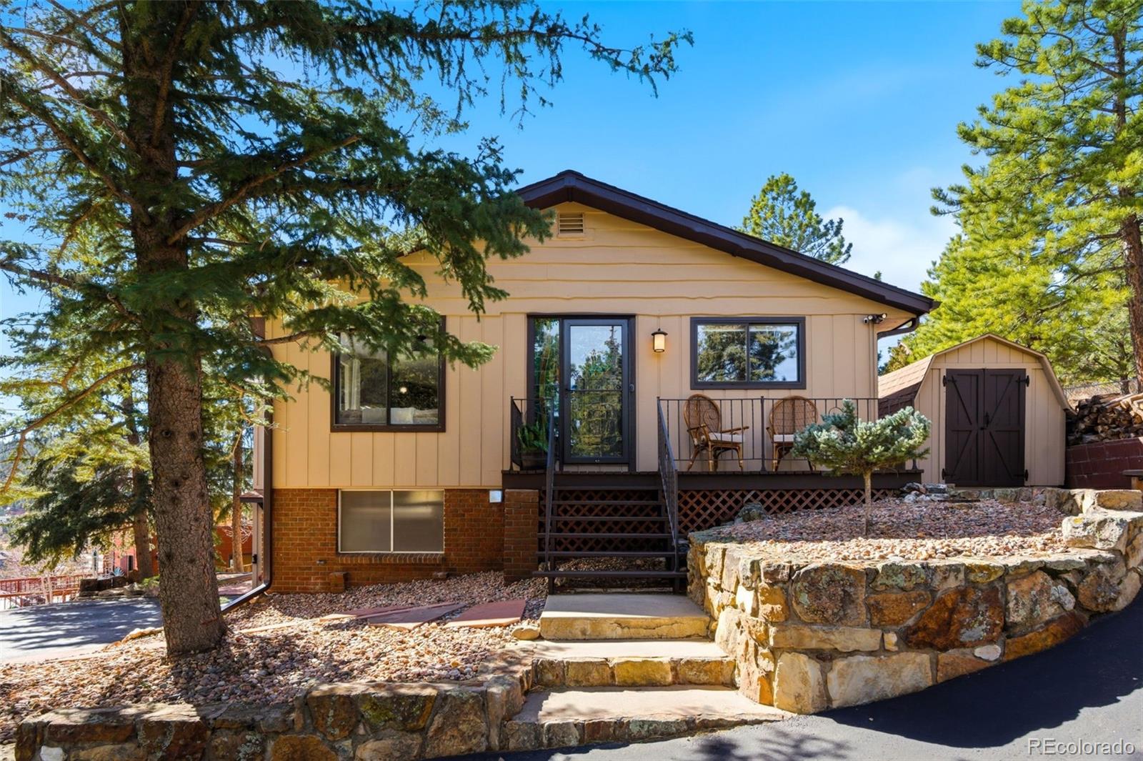 3155 Chestnut Circle Evergreen, CO 80439 - Photo 3 of 50 a front view of a house with garden