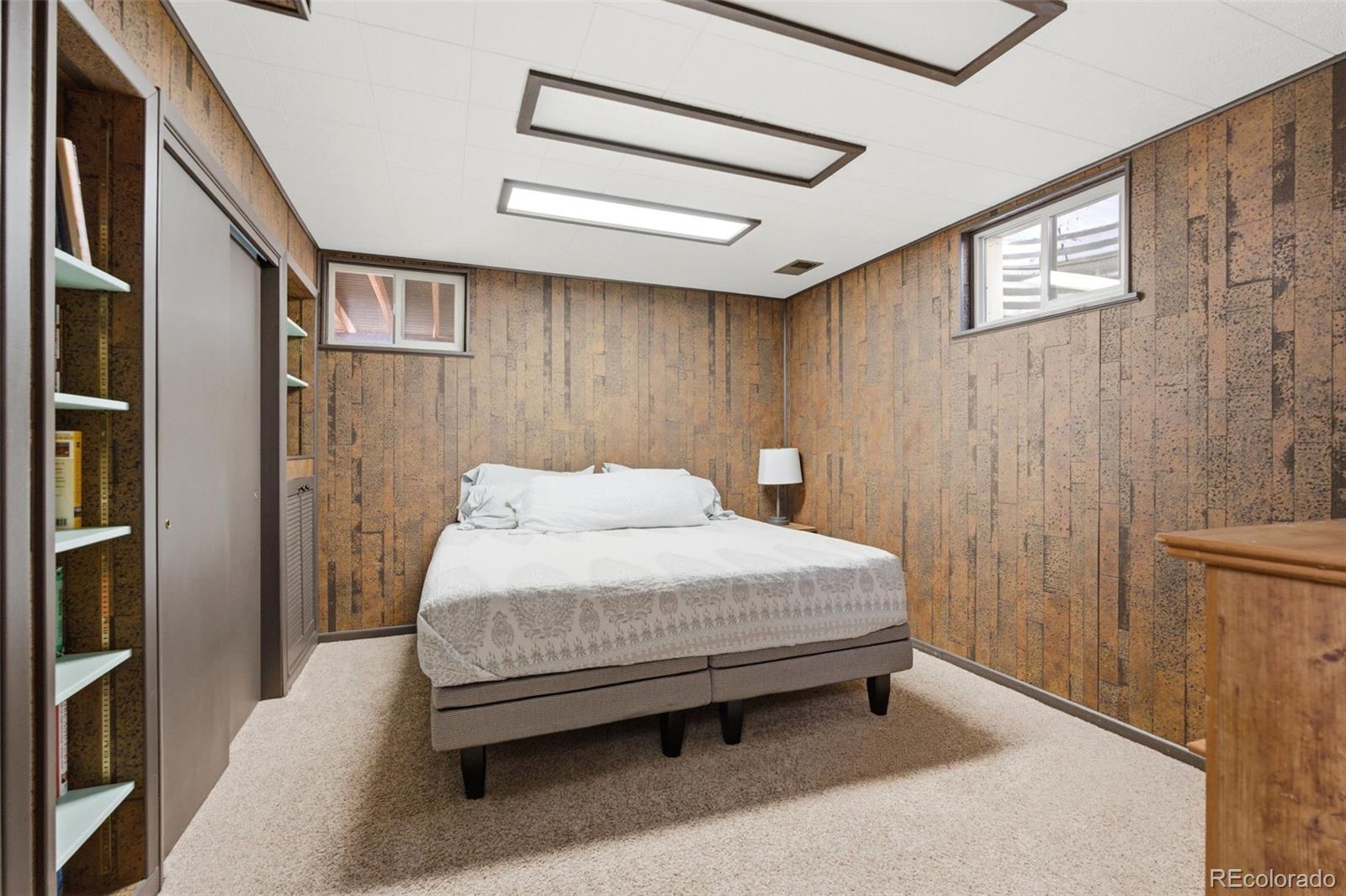 3155 Chestnut Circle Evergreen, CO 80439 - Photo 43 of 50 a bedroom with a bed and a book shelf