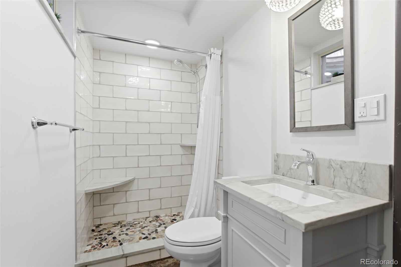 3155 Chestnut Circle Evergreen, CO 80439 - Photo 45 of 50 a bathroom with a sink toilet and shower