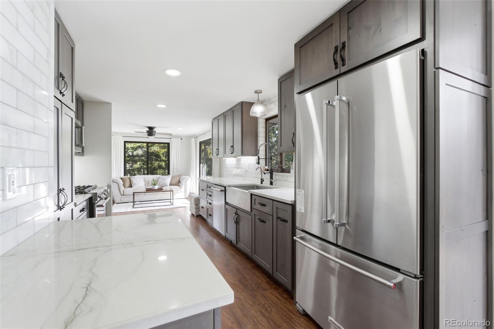 3155 Chestnut Circle Evergreen, CO 80439 - Photo 9 of 50 a kitchen with stainless steel appliances a refrigerator and a large window