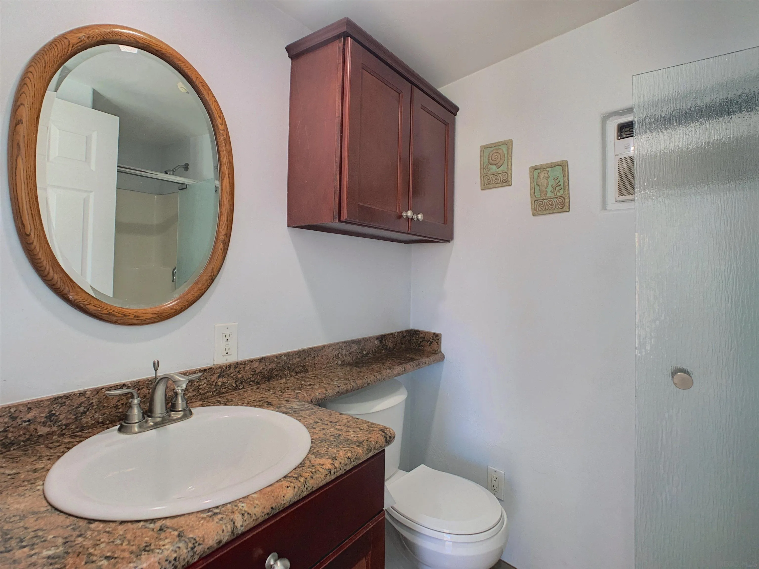 205 Highline Trail El Cajon, CA 92021 - Photo 38 of 45 a bathroom with a sink a mirror and a toilet