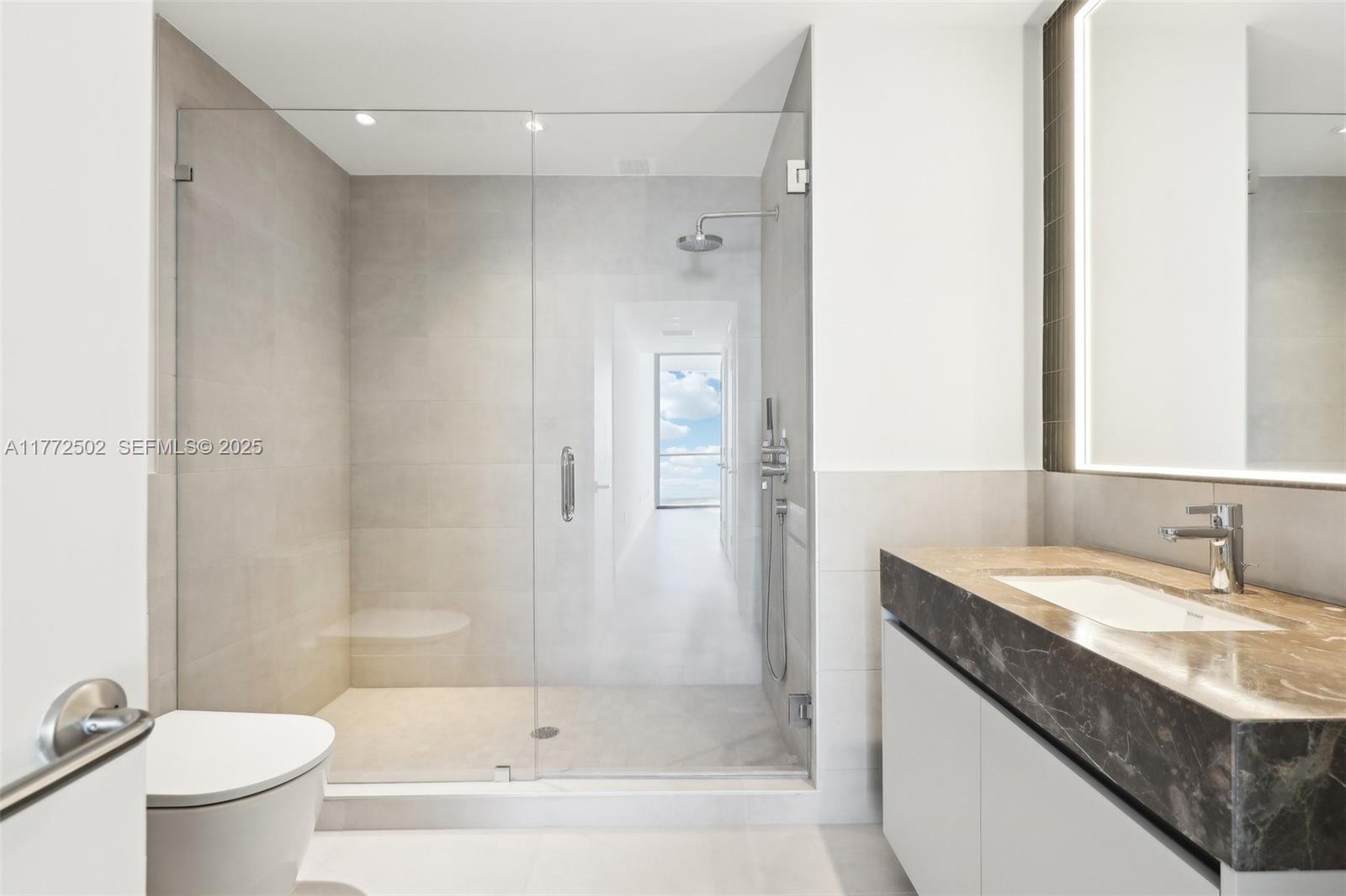 500 Alton Road, Unit 4201 05 Miami Beach, FL 33139 - Photo 25 of 61 a bathroom with a granite countertop sink a toilet and shower