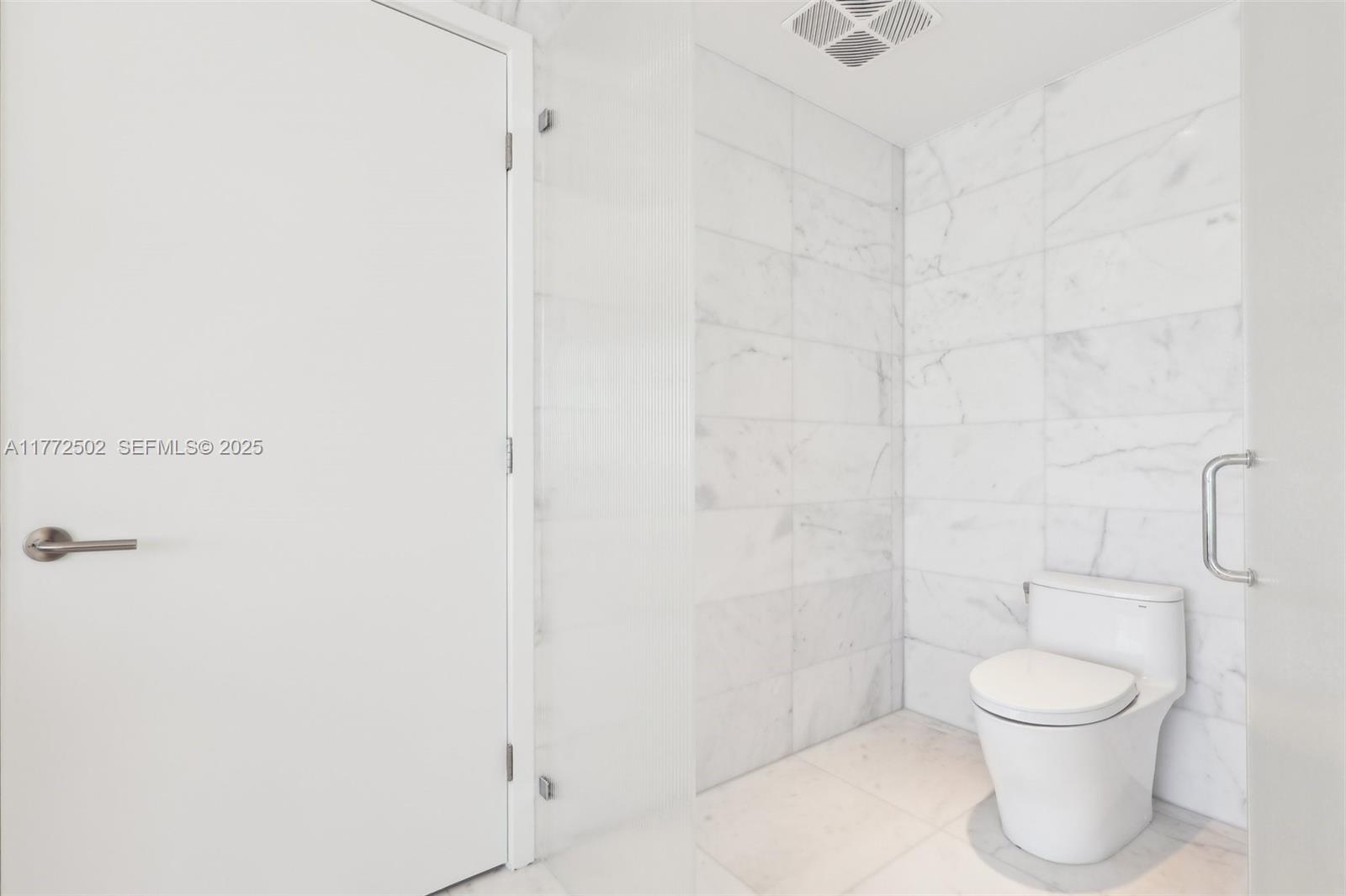 500 Alton Road, Unit 4201 05 Miami Beach, FL 33139 - Photo 34 of 61 a bathroom with a toilet and a shower