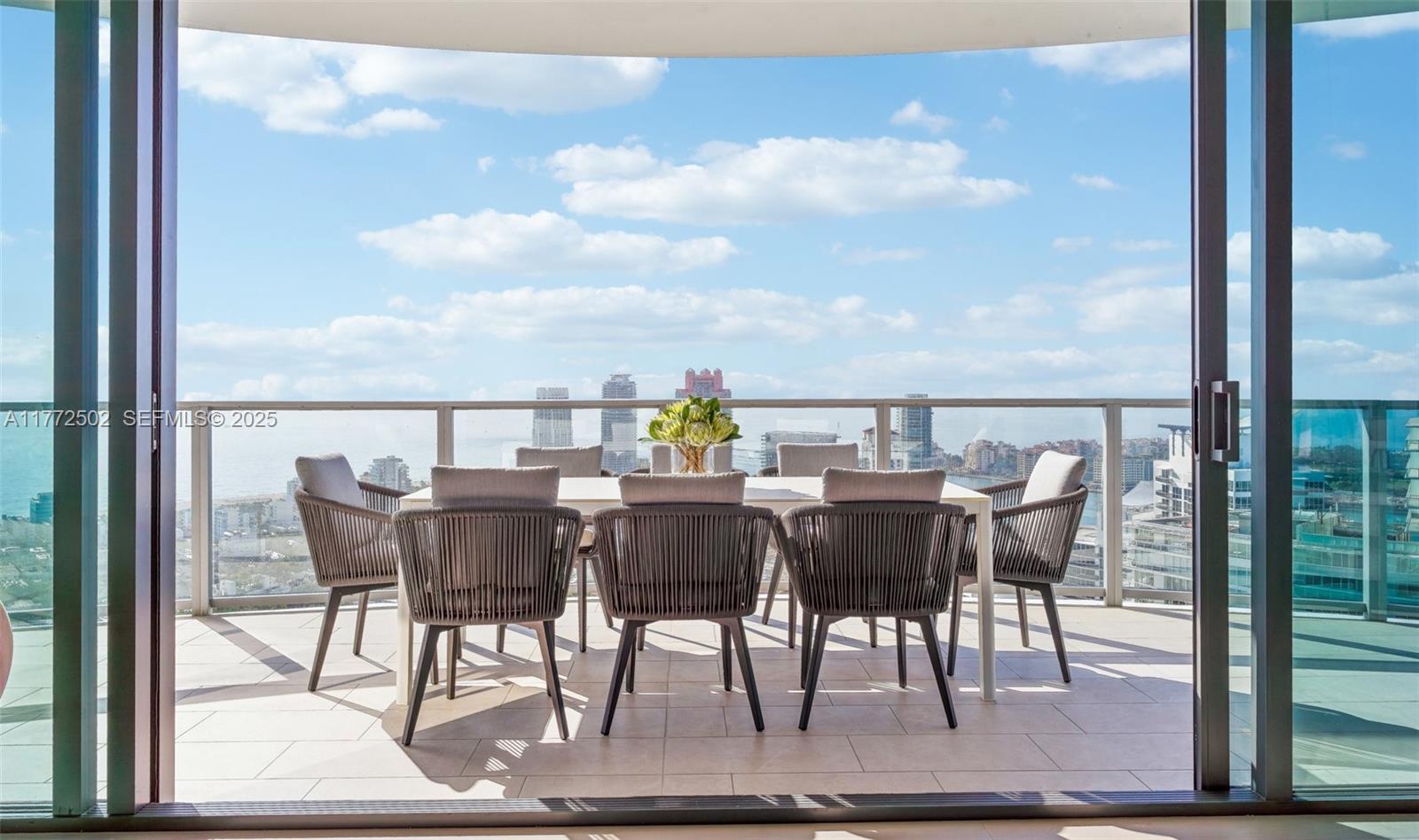 500 Alton Road, Unit 4201 05 Miami Beach, FL 33139 - Photo 44 of 61 a view of a dining table and chairs on the terrace
