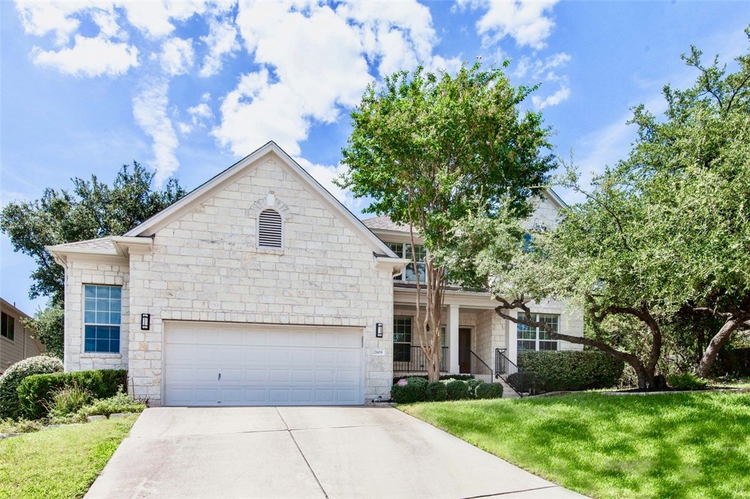 a front view of house with yard and green space