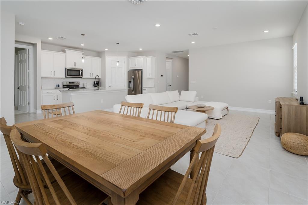 14643 Stillwater Way Naples, FL 34114 - Photo 14 of 50 a large kitchen with a table and chairs