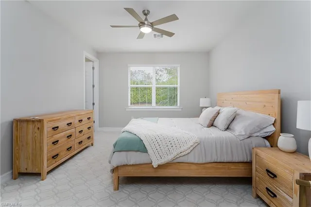 a bedroom with a bed dresser and a window