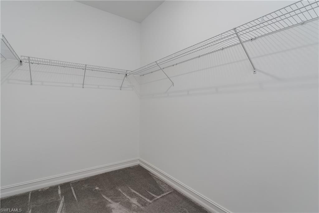 14643 Stillwater Way Naples, FL 34114 - Photo 19 of 50 a view of a room with racks on the wall