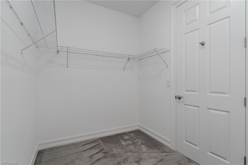 14643 Stillwater Way Naples, FL 34114 - Photo 20 of 50 a view of a room with racks on the wall