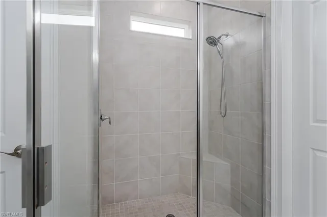 a bathroom with a glass shower door