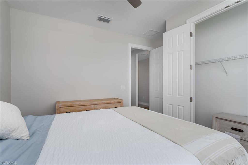 14643 Stillwater Way Naples, FL 34114 - Photo 27 of 50 a bedroom with a bed and a closet