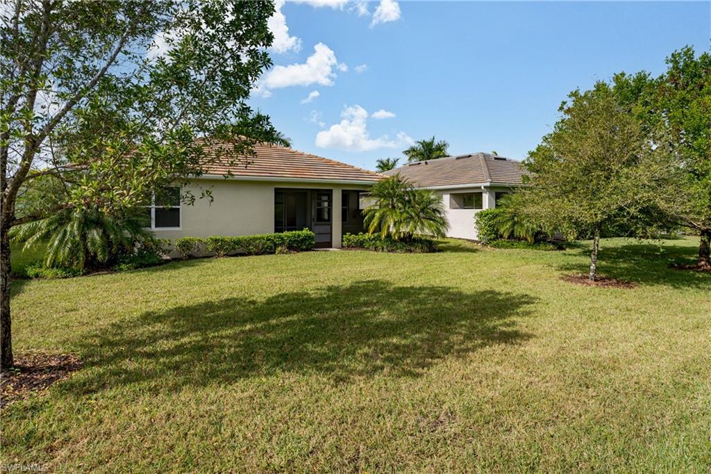 14643 Stillwater Way Naples, FL 34114 - Photo 31 of 50 a front view of house with yard and green space