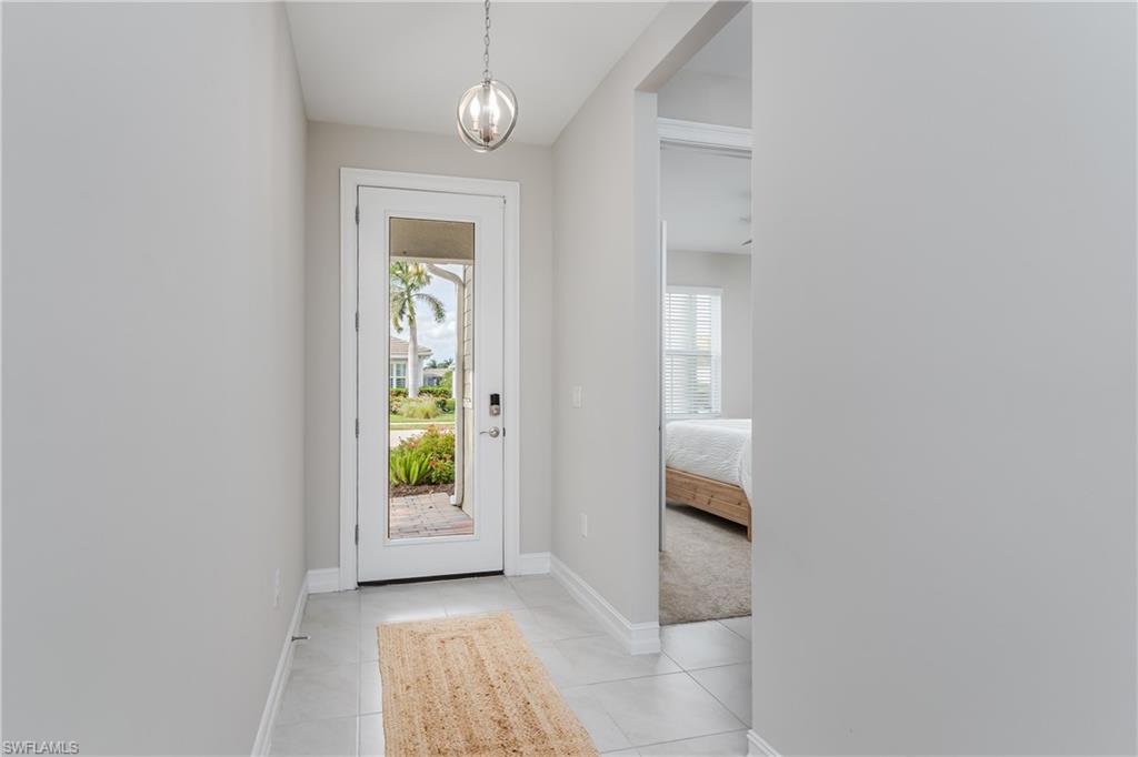 14643 Stillwater Way Naples, FL 34114 - Photo 5 of 50 a view of an entryway with wooden floor and a window