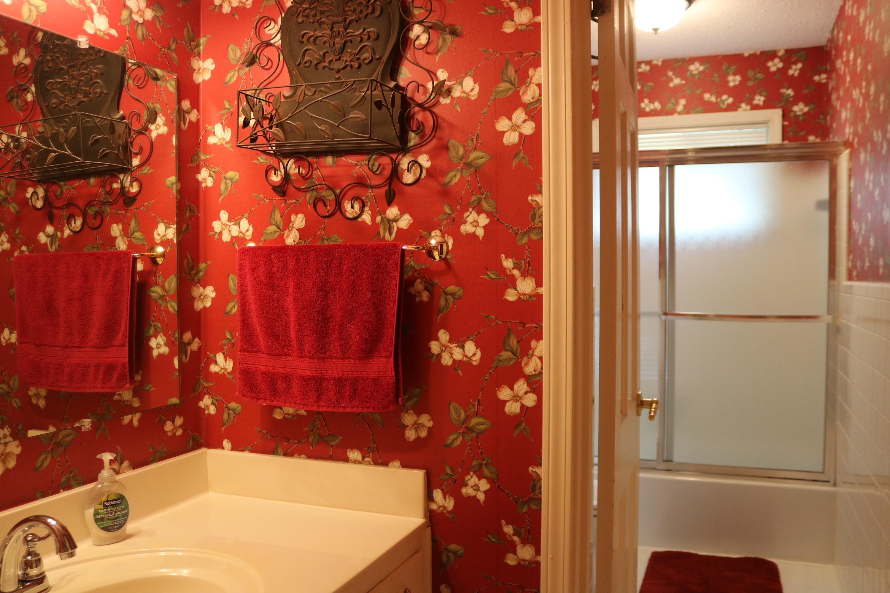 6233 Quince Road Memphis, TN 38119 - Photo 8 of 9 Bathroom featuring vanity, combined bath / shower with glass door, and wallpapered walls