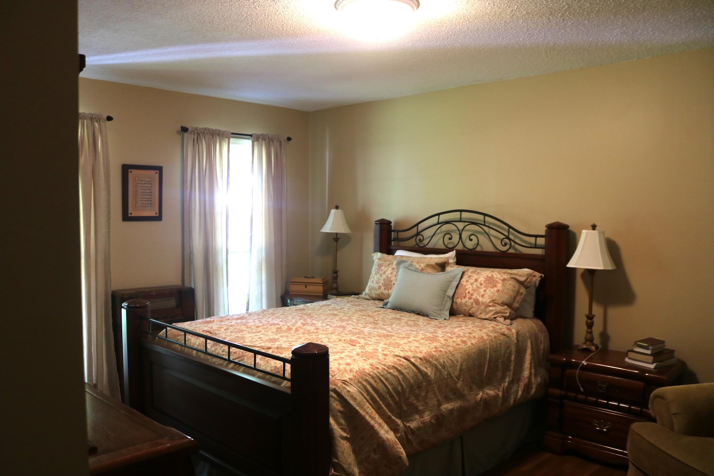 6233 Quince Road Memphis, TN 38119 - Photo 9 of 9 Bedroom featuring a textured ceiling and dark wood-style flooring