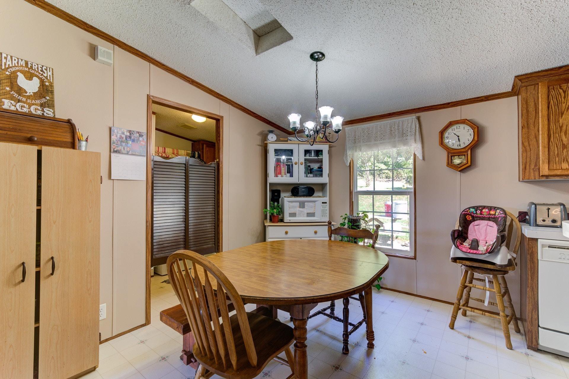 1383 6 Mile Post Road Callaway, VA 24067 - Photo 11 of 30 a view of a dining room with furniture and chandelier