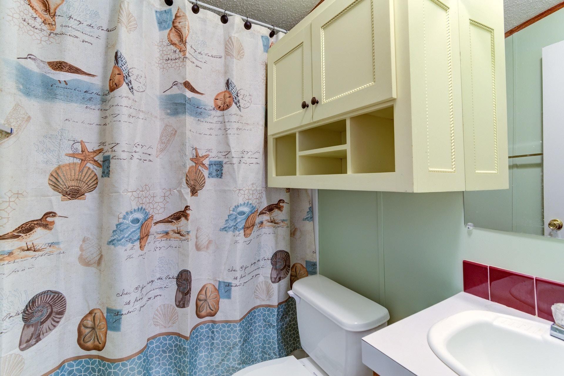 1383 6 Mile Post Road Callaway, VA 24067 - Photo 21 of 30 a bathroom with a toilet sink and shower curtain