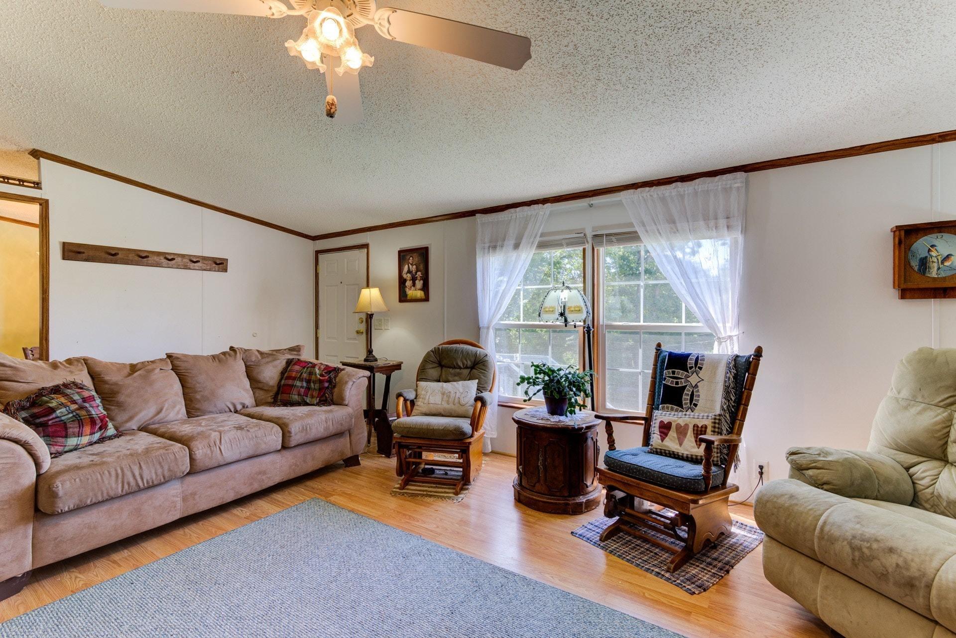 1383 6 Mile Post Road Callaway, VA 24067 - Photo 8 of 30 a living room with furniture a flat screen tv and a large window