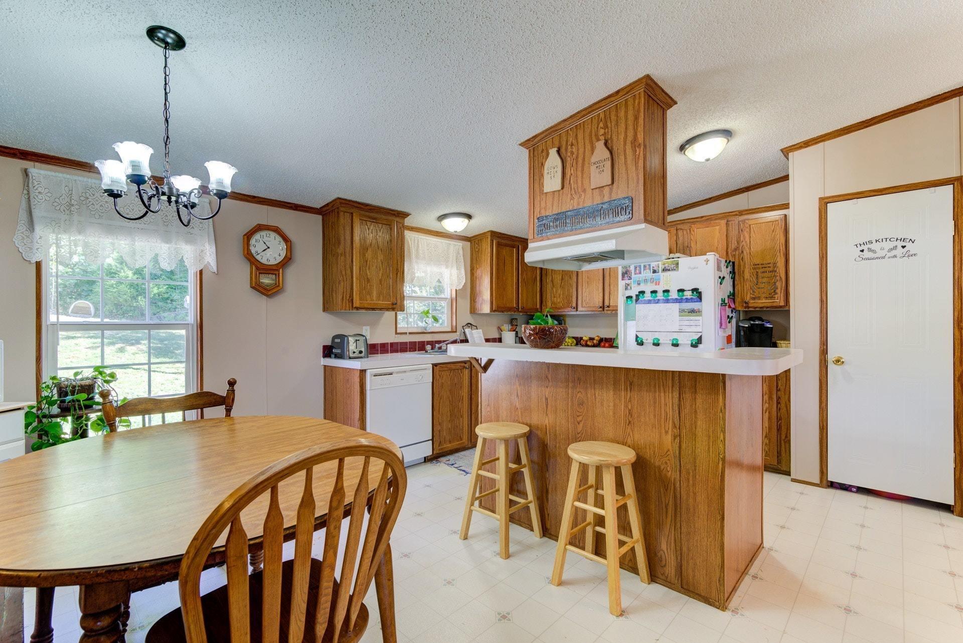 1383 6 Mile Post Road Callaway, VA 24067 - Photo 9 of 30 a view of a dining room kitchen furniture and a chandelier