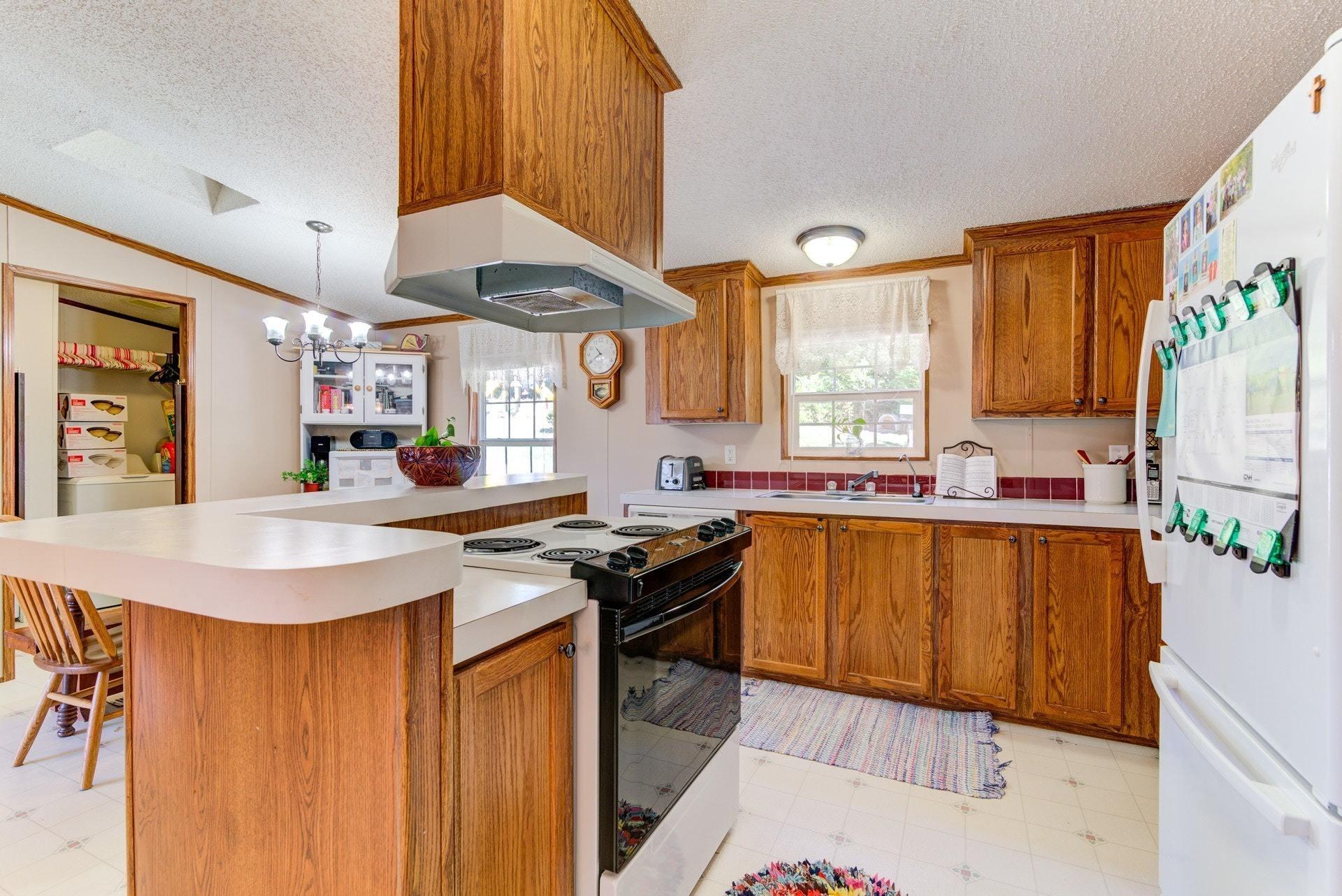 1383 6 Mile Post Road Callaway, VA 24067 - Photo 10 of 30 a kitchen with stainless steel appliances granite countertop a sink stove and refrigerator