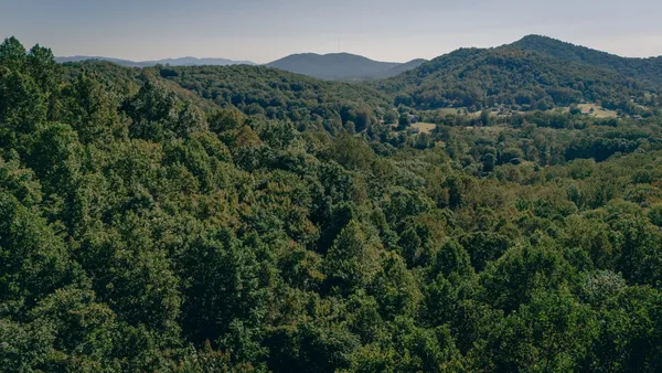 a view of a mountain in the distance in a field