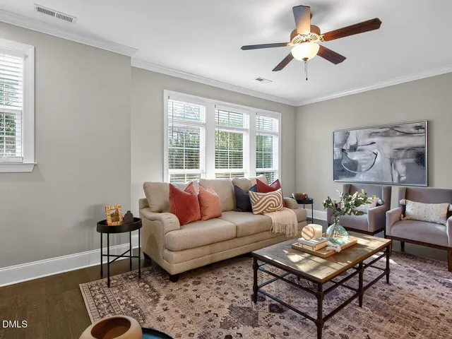 a living room with furniture a rug and a window