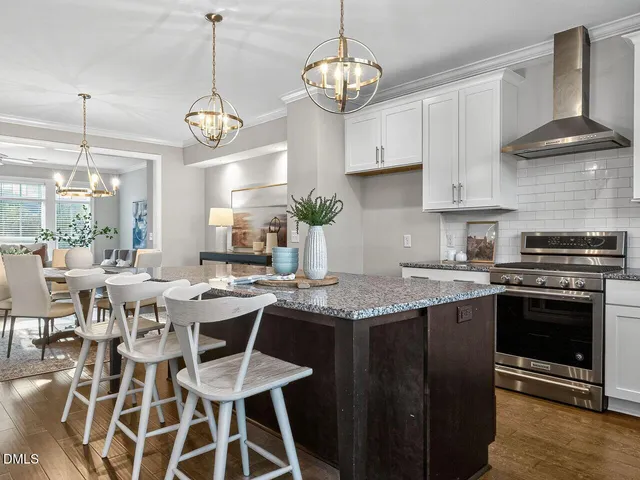 a kitchen with a dining table and chairs