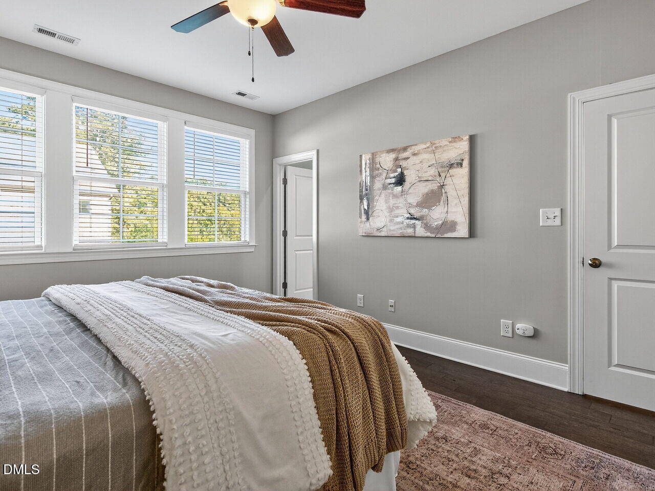 1609 Bowery Drive Raleigh, NC 27607 - Photo 22 of 30 a bedroom with a large bed and a chandelier
