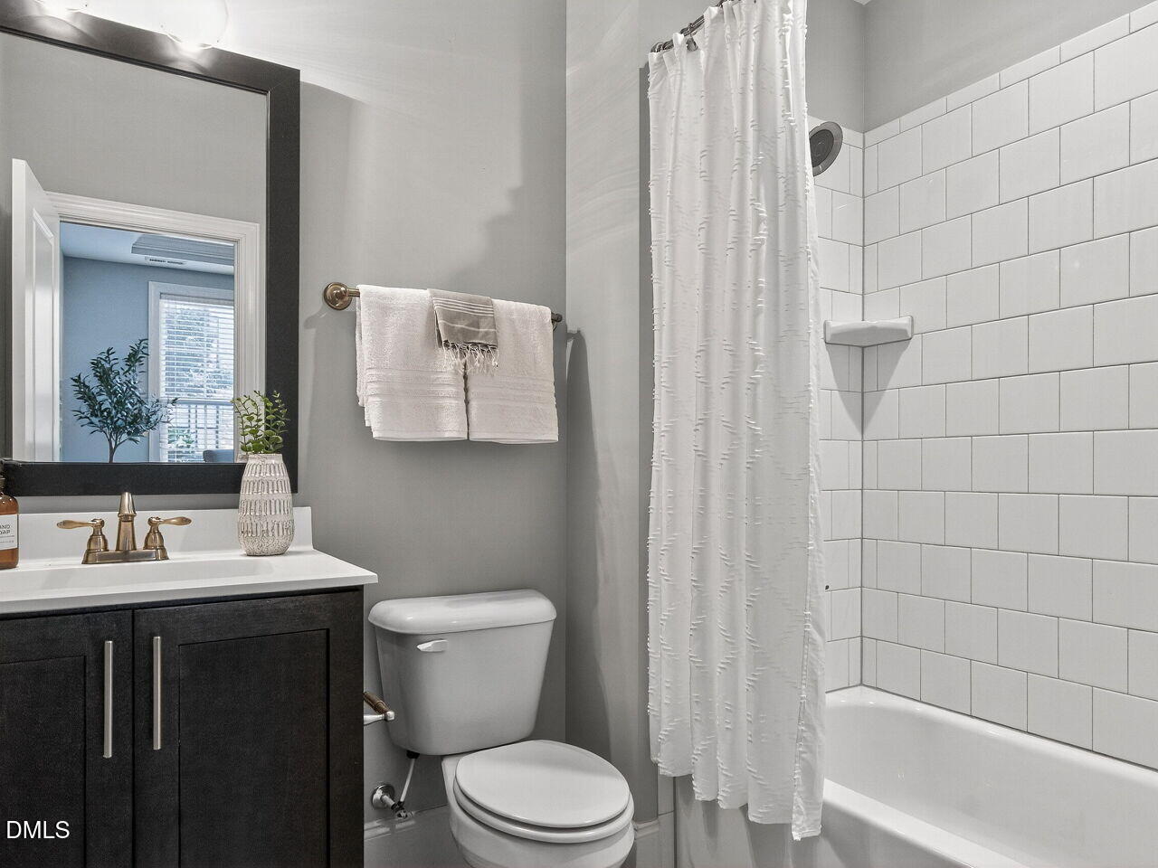 1609 Bowery Drive Raleigh, NC 27607 - Photo 8 of 30 a bathroom with a sink a toilet and shower curtain