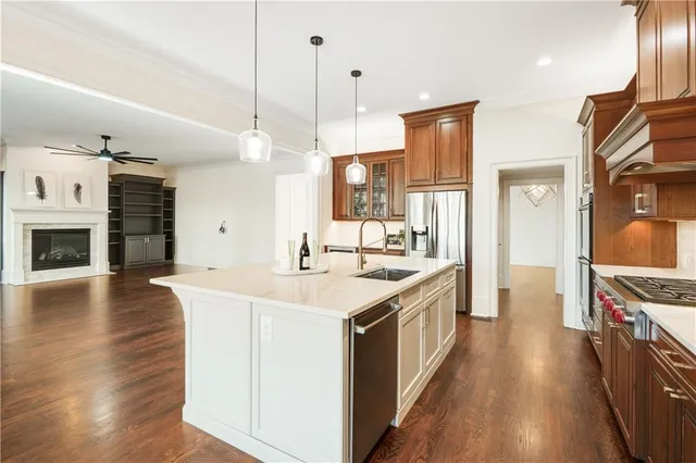 a kitchen with stainless steel appliances granite countertop a sink stove and refrigerator