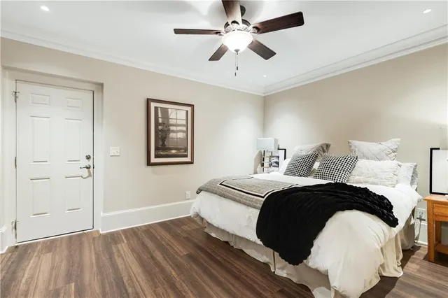 a spacious bedroom with a bed and a ceiling fan