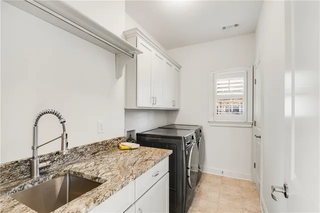 a view of a kitchen with sink a stove and furniture